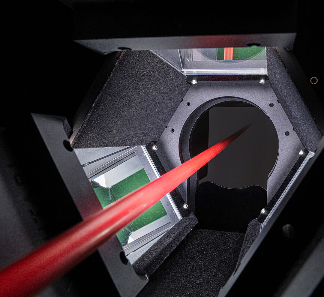 Inside the nLine inspection system: Three high-speed cameras for 360° inline monitoring of a red cable during the extrusion process.